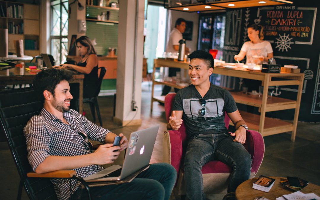 photograph of men having conversation seating on chair